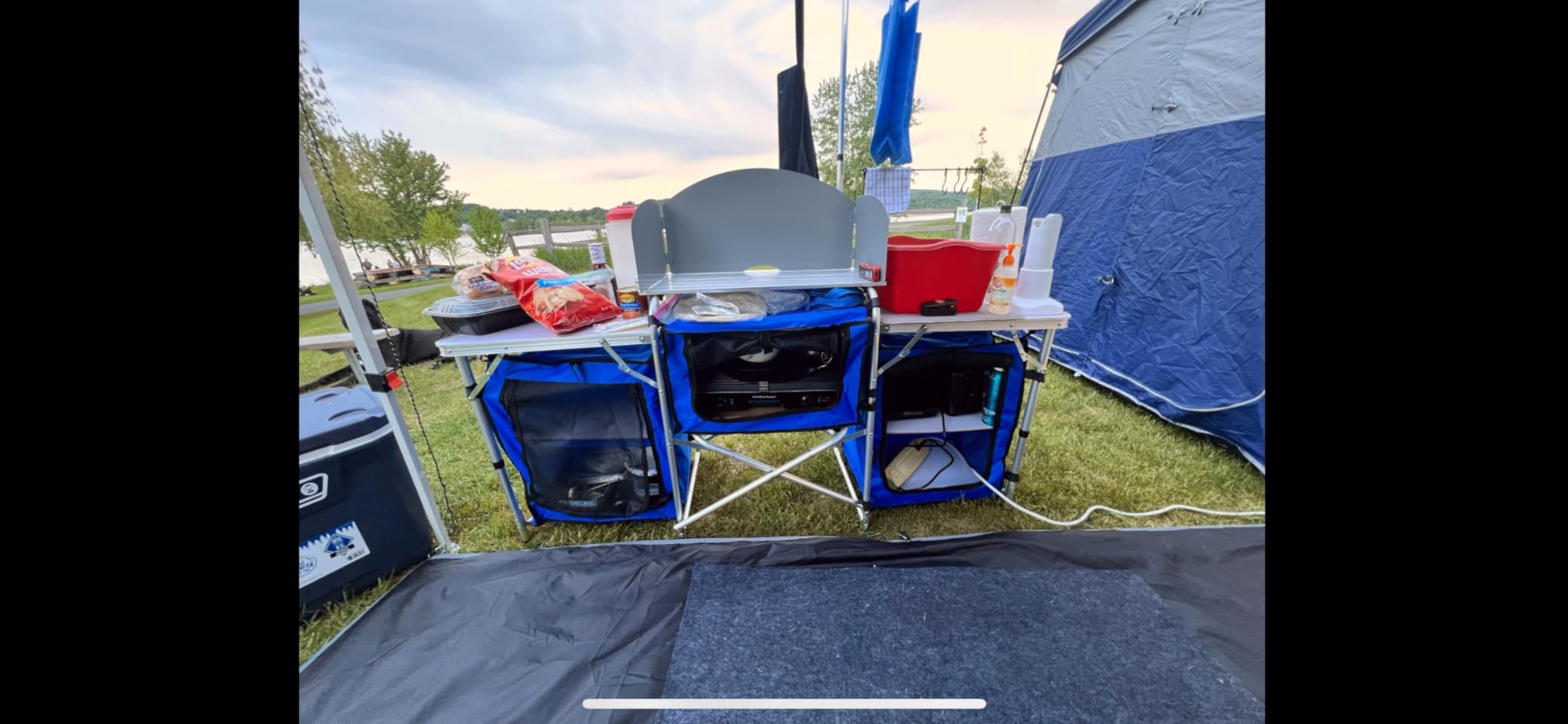 Outsunny Camping Kitchen Table, Portable Folding Camp Kitchen, Aluminum Cook Station with 3 Fabric Cupboards, Windshield, Carrying Bag (Black) customer photo 2